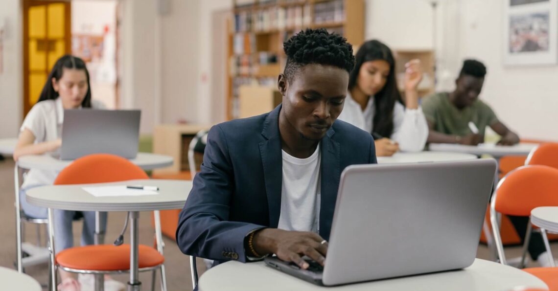 A black person studying on in a class