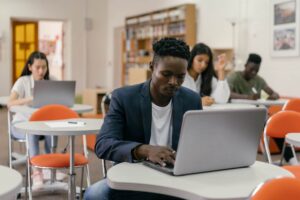 A black person studying on in a class